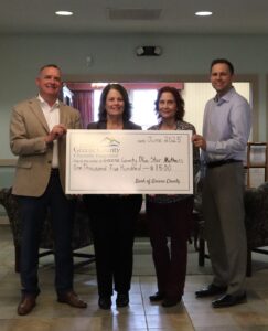 Bank employees presenting big checks to Blue Star Mothers
