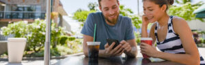 Two people looking at a phone smiling