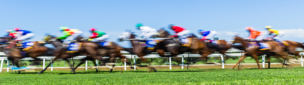 Horses racing down a track