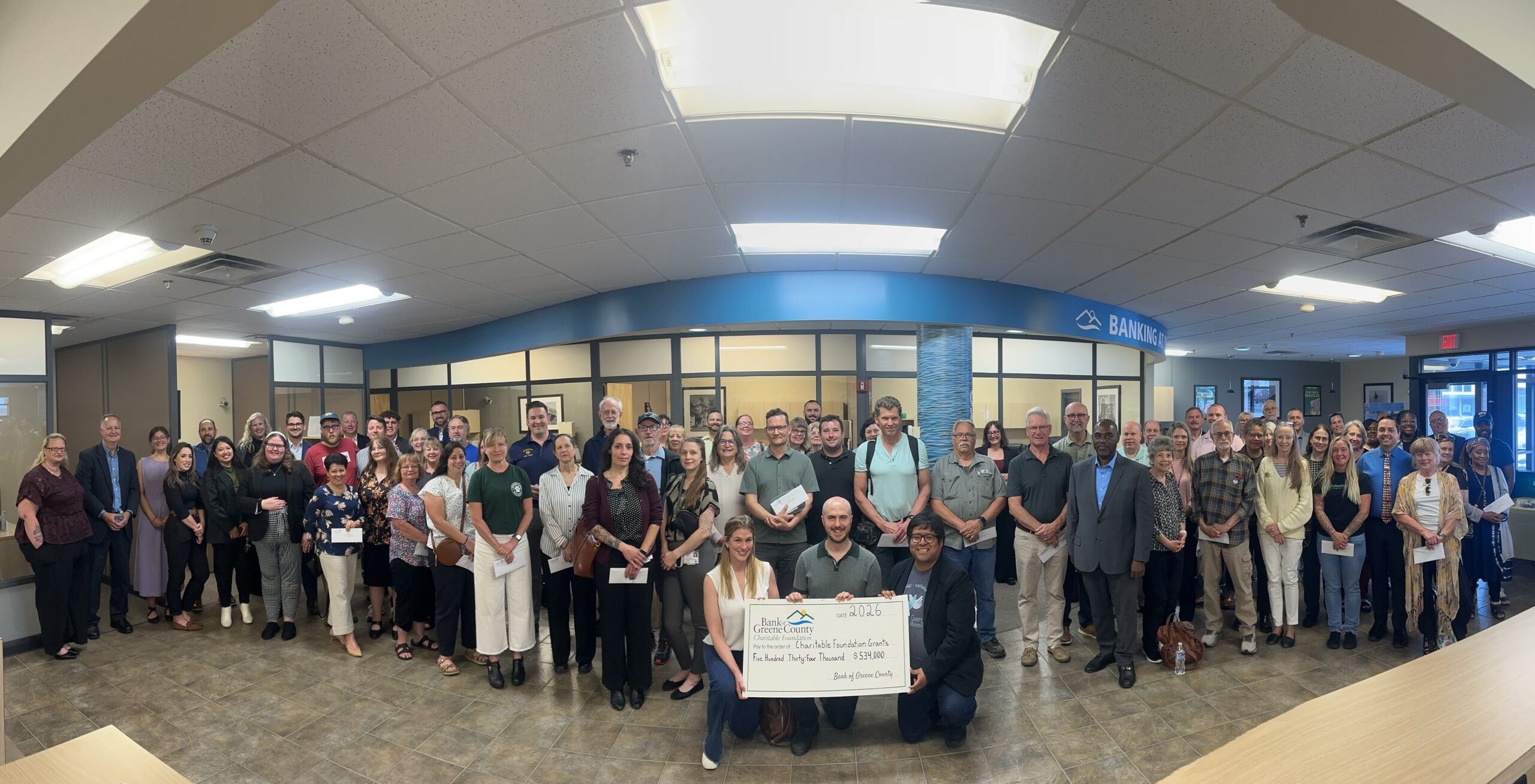 Greenport branch charitable ceremony group picture with big check